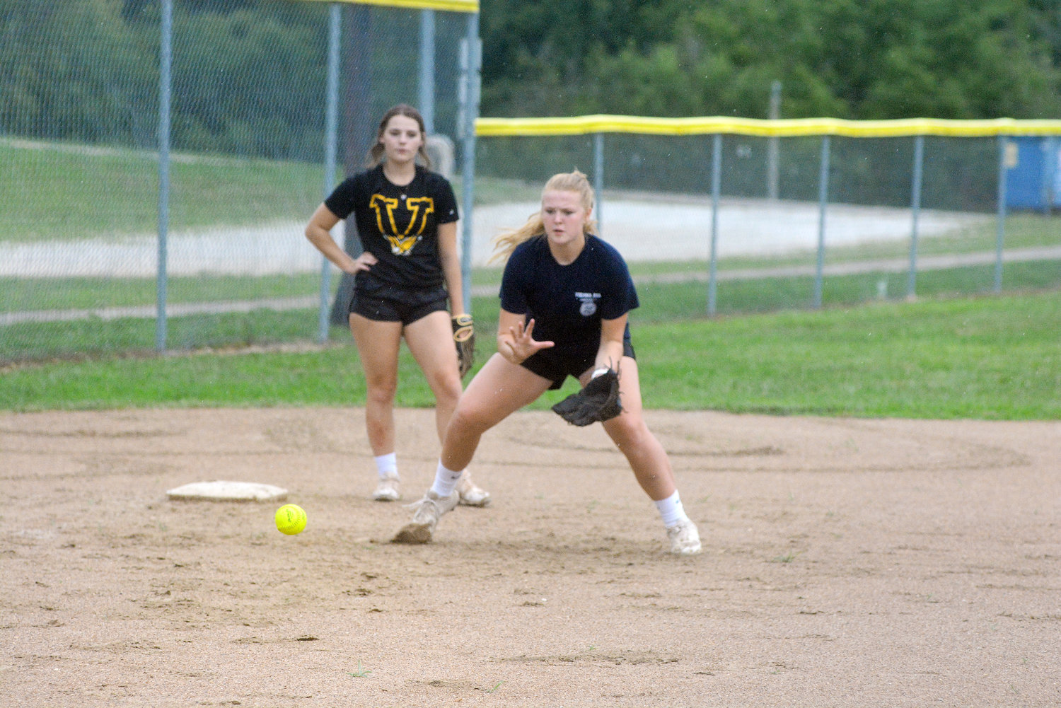 Ava Kloeppel (right) positions herself to field a ground ball at third base during a recent practice session for Vienna’s Lady Eagles on their home softball field at Vienna City Park.